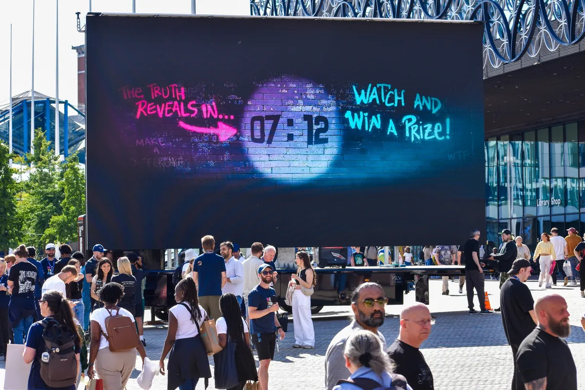 The We The Free truck screen counting down in Birmingham city centre, surrounded by a crowd